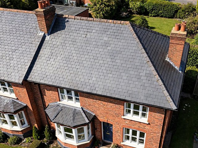Illustration: a slate roof on a red-brick semi-detached house, seen from above