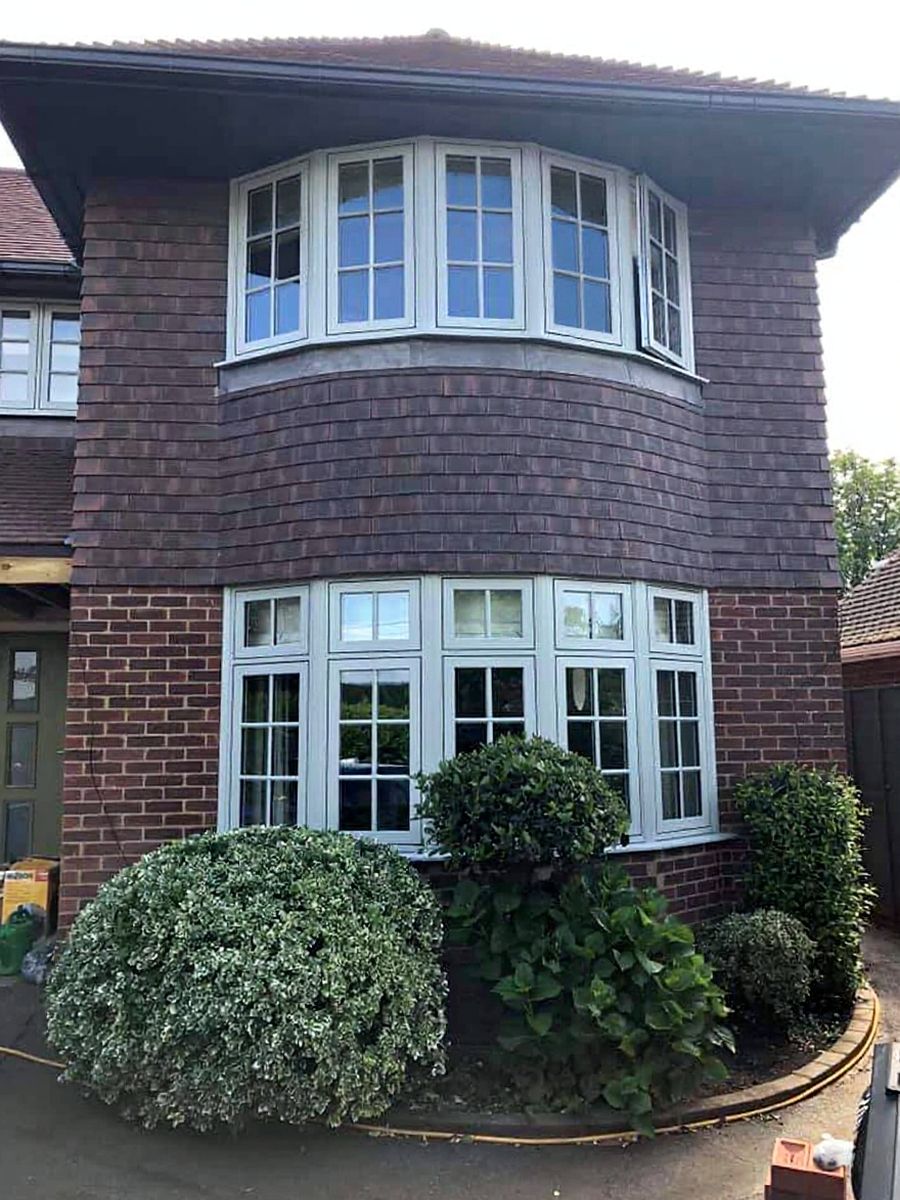 The same home before, with pale duck-egg grey window frames